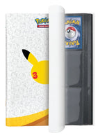 30th Celebration binder open with a Pokemon card in a black 9-pocket page and elastic strap